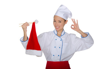 Chef holding chopsticks cap of Santa Claus