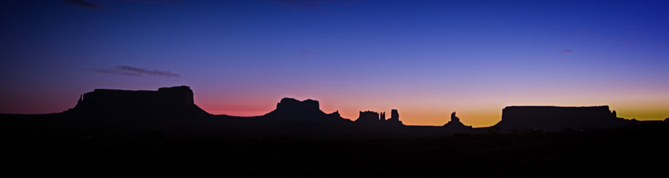Panoramic photo of Monument Valley at night just before sunrise