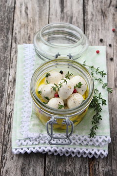 In olive oil marinated mozzarella with pepper and thyme.