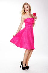 Sexy girl wearing pink dress with candy. Valentine's day