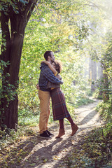 Loving couple walking and hugging in the park