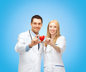 smiling doctors cardiologists with heart