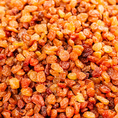 Golden dried raisins background
