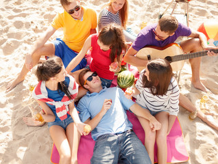 group of friends having fun on the beach
