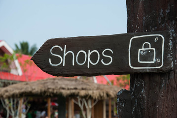wooden signage indicating shopping area to the market