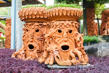Artificial tree pot look like human face in the garden