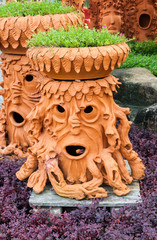 Artificial tree pot look like human face in the garden