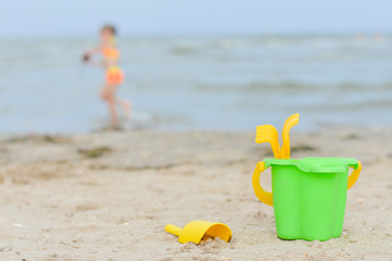 Little girl playng on sandy beach