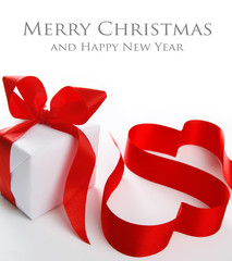 White gift box with red ribbon