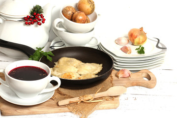 homemade pierogi (ravioli)  and clear red borscht 