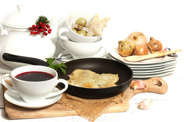 homemade pierogi (ravioli)  and clear red borscht 