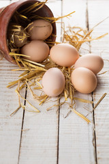 Chicken eggs on wooden background