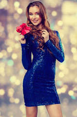 attractive young brunette girl with shining dress and gift box