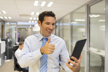 Businessman chatting on internet with Tablet Pc in office