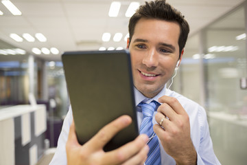 Businessman chatting on internet with Tablet Pc in office