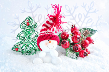 Snowman with Christmas decorations on snow