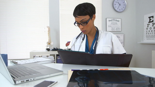 Doctor working in office with computer