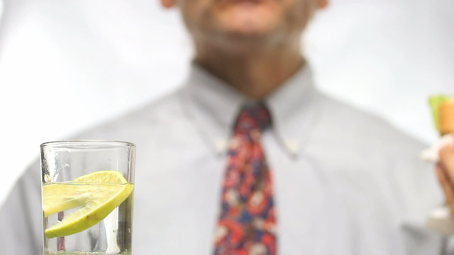 out of focus man eating a sandwich