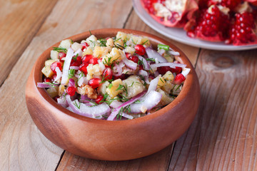 Oriental pomegranate seeds salad with potatoes, dill and walnuts