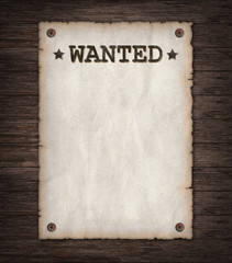 Torn Wild West wanted poster on old wooden wall 