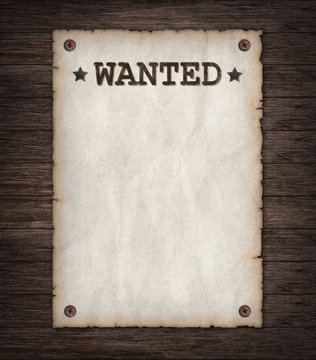 Torn Wild West wanted poster on old wooden wall 