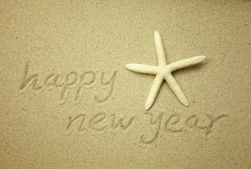 Fototapeta na wymiar new year message on the sand beach
