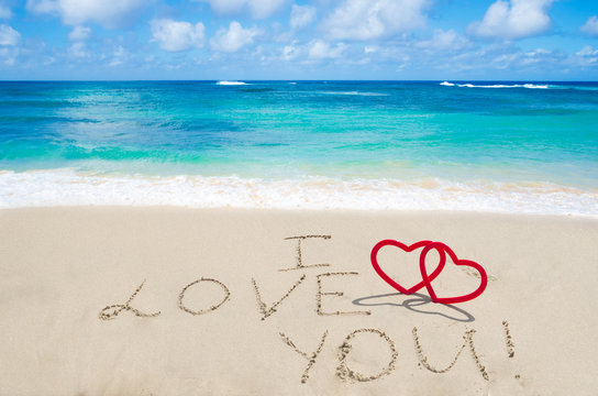 Sign "I love you" on the sandy beach