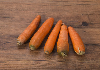 Organic raw carrots of rustic wood