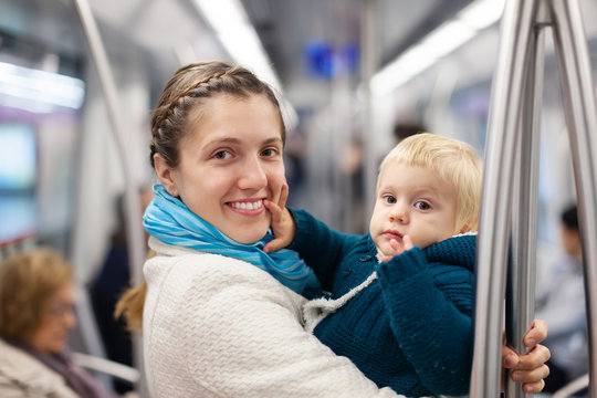 young mother with baby in subway