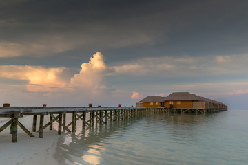 Maldives beach villas in sunset scenery