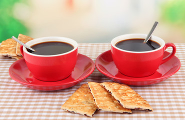 Red cups of strong coffee and cookies