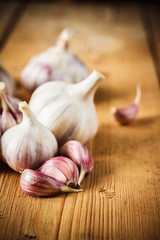 Raw garlic on wooden background