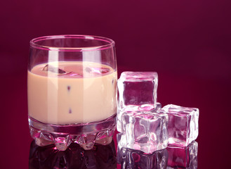 Baileys liqueur in glass on pink background