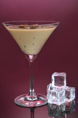 Baileys liqueur in glass on pink background