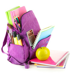 Purple backpack with school supplies isolated on white