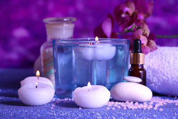 Beautiful spa setting with orchid on purple background