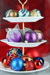 Christmas decorations on dessert stand, on color background