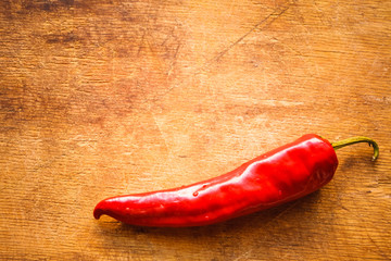 Red peppers on old wooden table
