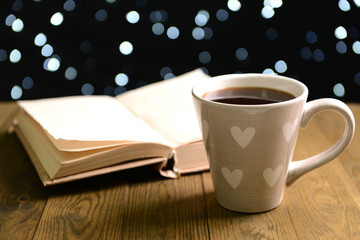 Composition of book with cup of coffee