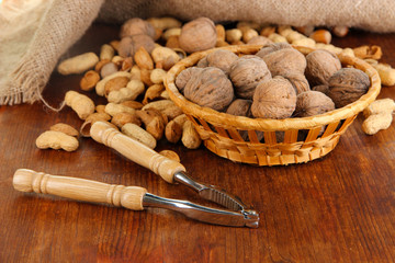 Nutcracker with nuts on wooden table close-up