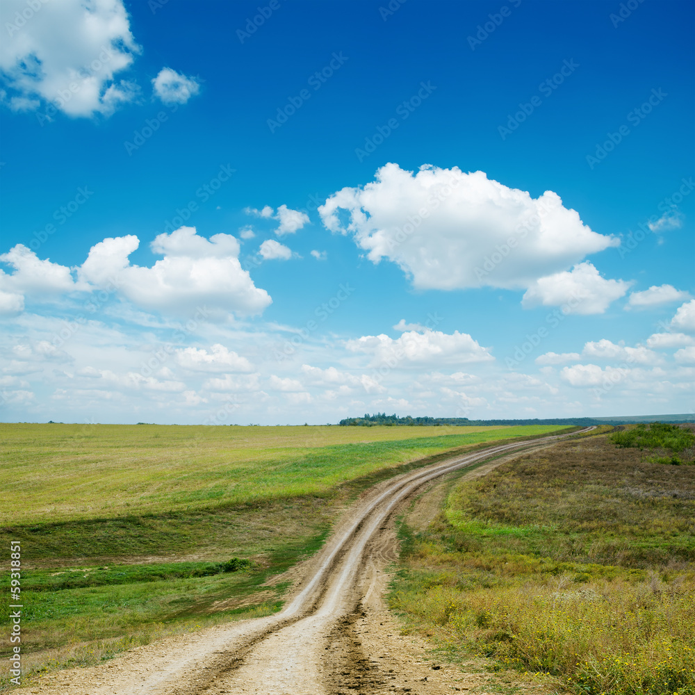 Wall mural dirty road and blue sky with clouds