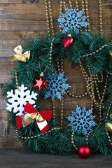 Christmas wreath with decorations, on  color wooden background