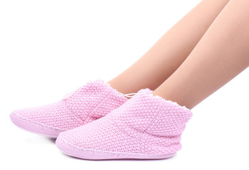 Female legs in home winter shoes, isolated on white