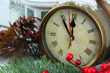 Clock with fir branches and Christmas decorations close up