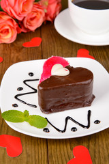 Sweet cake with chocolate on plate on table close-up