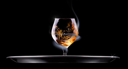 Cognac or brandy on a black