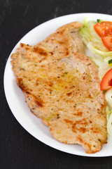 fried turkey with vegetables on plate