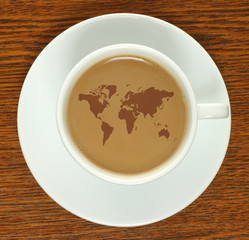 Obraz premium Coffee cup with map on a wooden background .