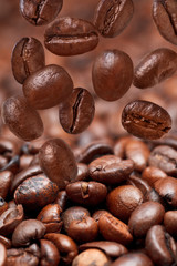 many falling beans and dark roasted coffee