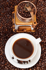 cup of coffee and roasted beans